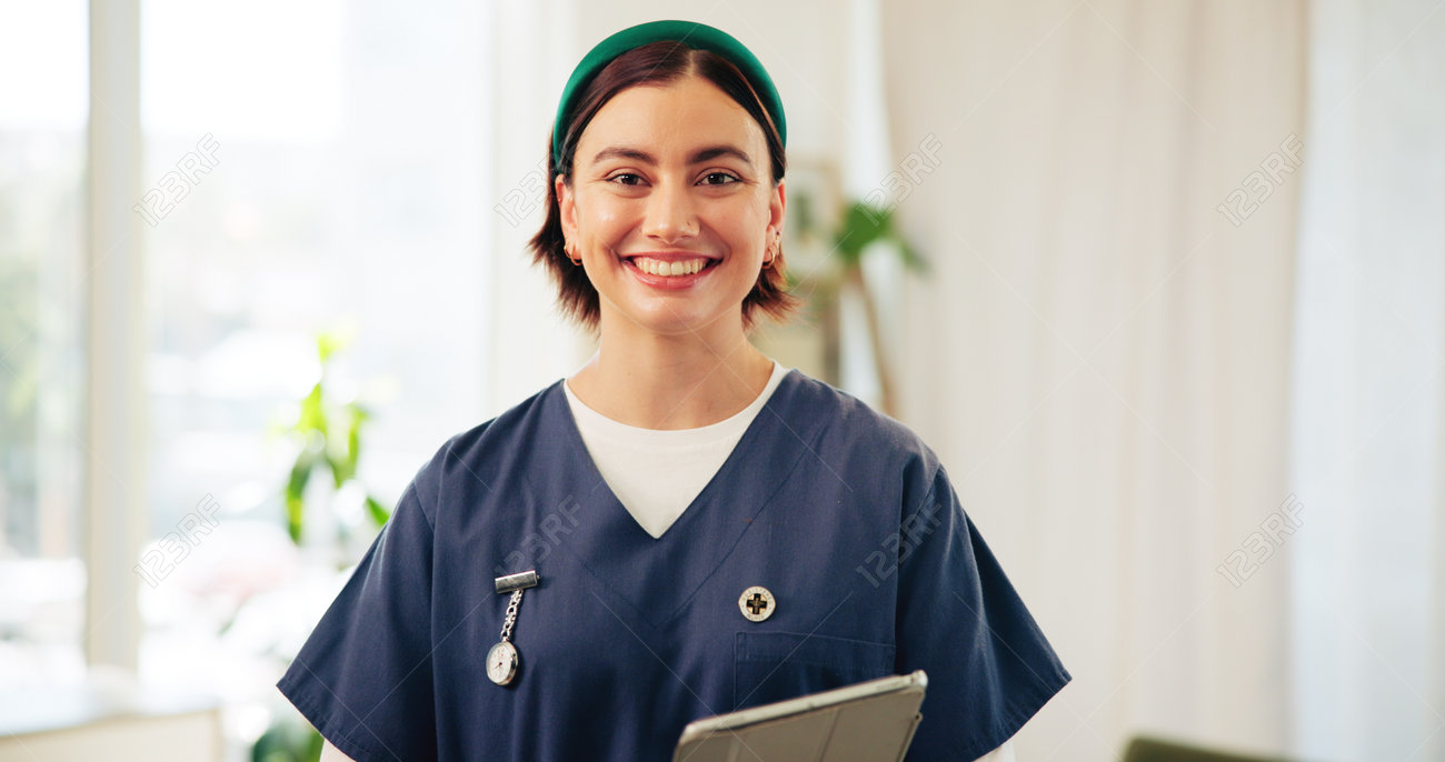 Caregiver helping a woman use a tablet, both smiling.